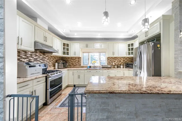 a kitchen with stainless steel appliances granite countertop a sink and cabinets