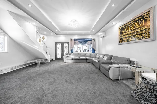 a living room with furniture and a chandelier