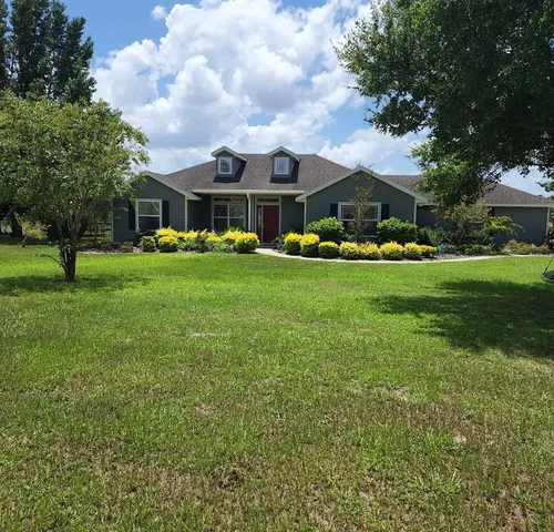 a front view of a house with garden
