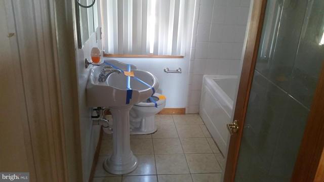 1215 Cedarcroft Road Baltimore, MD 21239 - Photo 2 of 11 a bathroom with a sink and toilet
