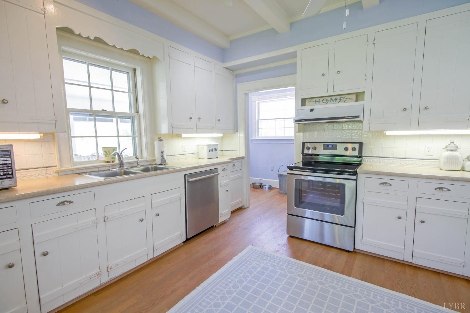 1861 Link Road Lynchburg, VA 24503 - Photo 35 of 99 a kitchen with granite countertop white cabinets and white appliances
