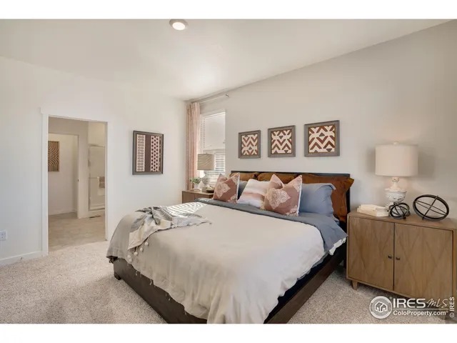 a bedroom with a bed and a night stand