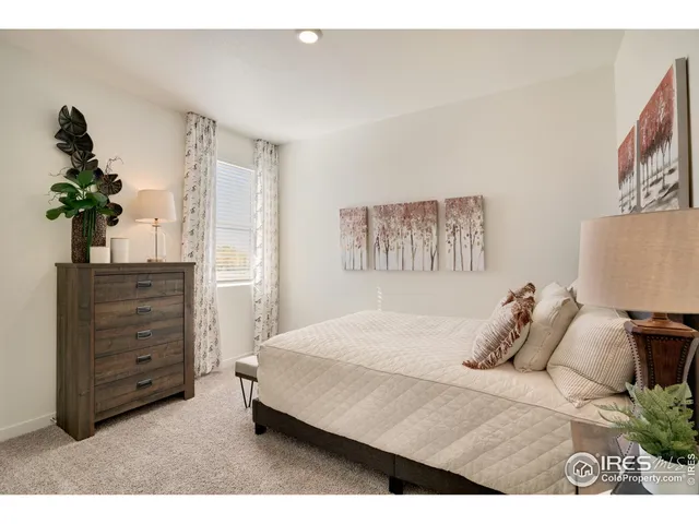 a bedroom with a bed and a potted plant