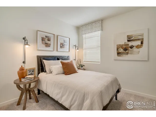 a bedroom with a bed a table and chair