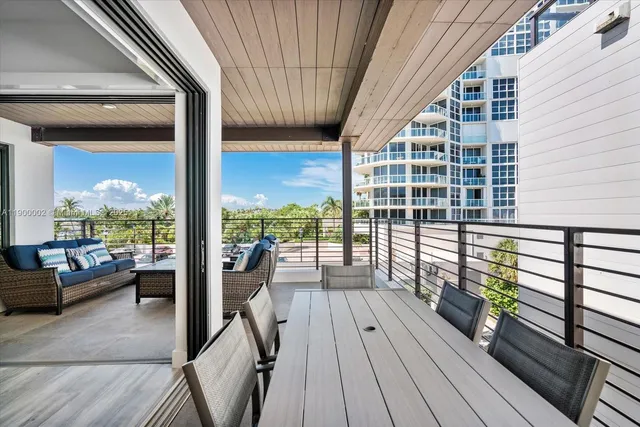 a view of balcony with wooden floor and seating space