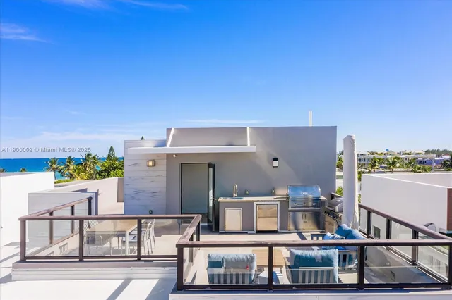 a view of balcony with two chairs and potted plants