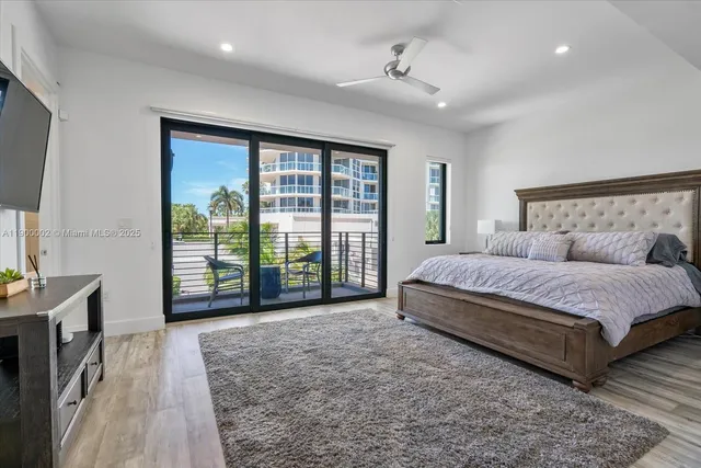 a spacious bedroom with a large bed and a large window