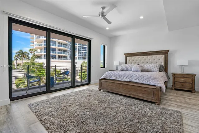 a bathroom with a tub a sink and a large mirror
