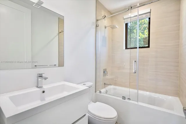 a utility room with sink dryer and washer
