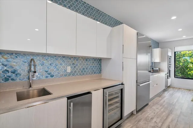 a kitchen with a sink and cabinets