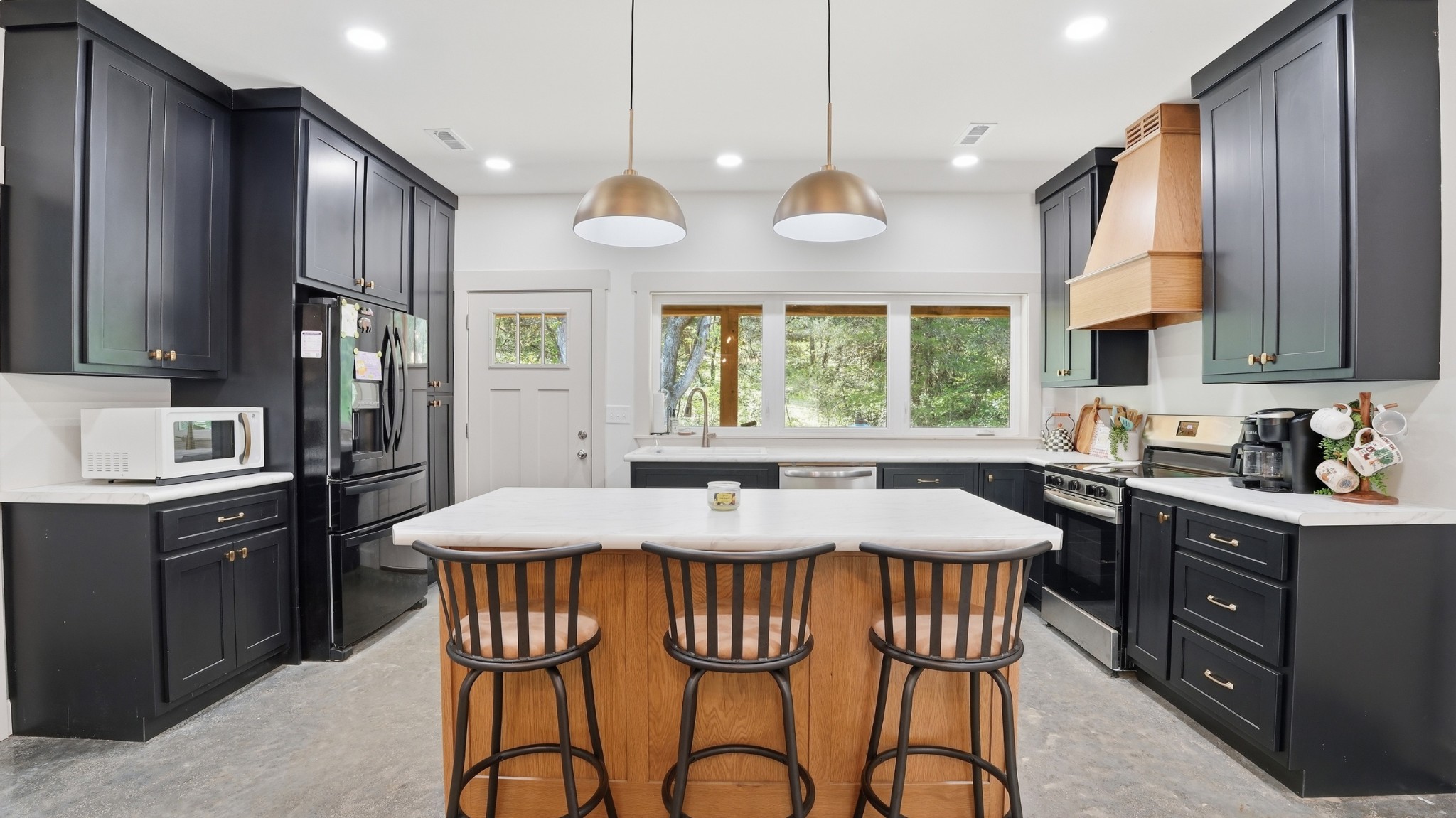 318 Robinson Road Dellrose, TN 38453 - Photo 11 of 56 a kitchen with stainless steel appliances granite countertop a stove a sink dishwasher a dining table and chairs with wooden floor