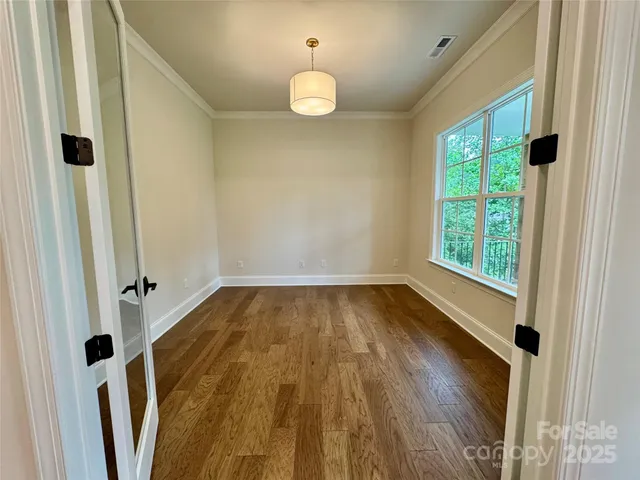 a view of a livingroom with wooden floor and window