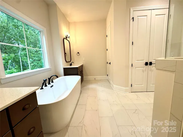 a bathroom with a sink vanity tub and shower