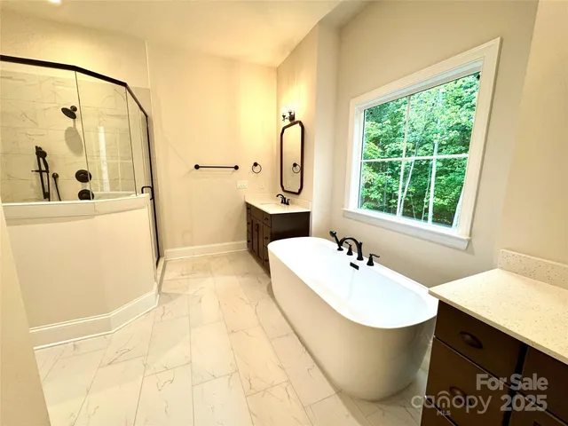 a bathroom with a sink and mirror with bathtub