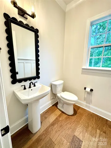 a bathroom with a sink toilet and mirror