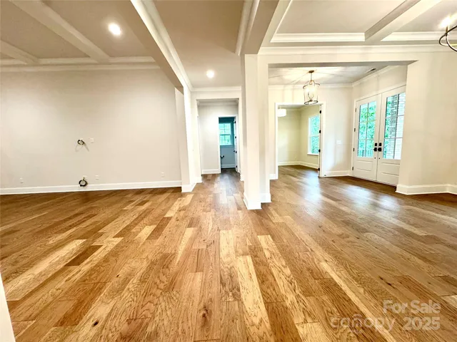 a view of a room with wooden floor and natural light