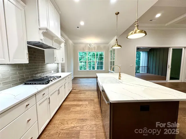 a large kitchen with stainless steel appliances kitchen island a large island in the center