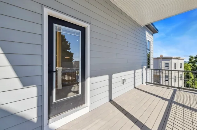 a view of a balcony with wooden floor