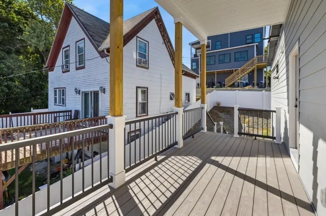 a view of a house with wooden deck