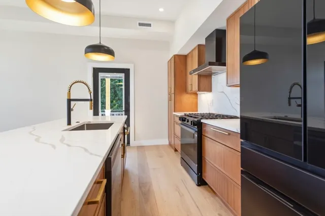 a kitchen with a sink and a refrigerator