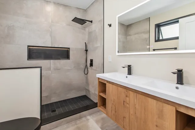 a bathroom with a sink a toilet and mirror