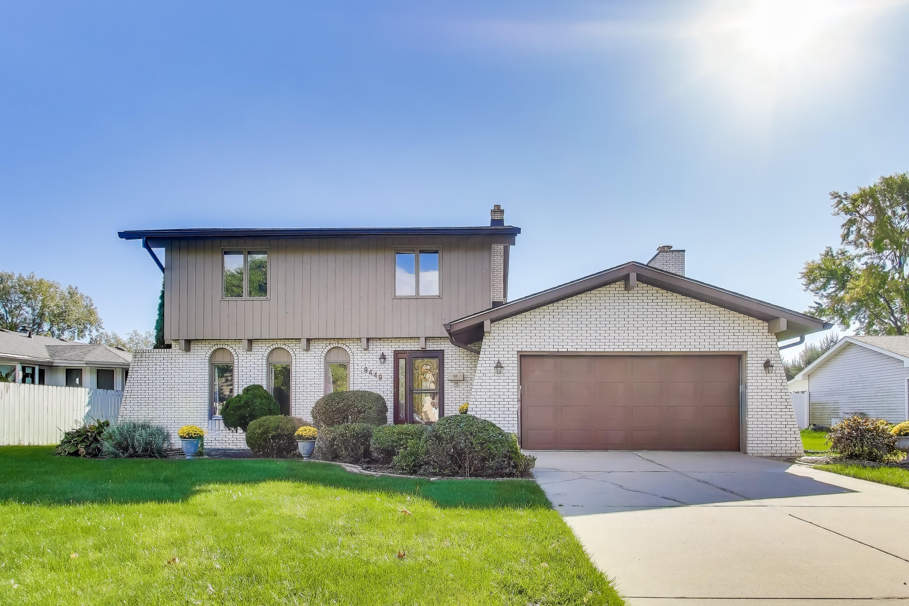 9449 Primrose Lane Munster, IN 46321 - Photo 1 of 34 a front view of a house with a yard and garage