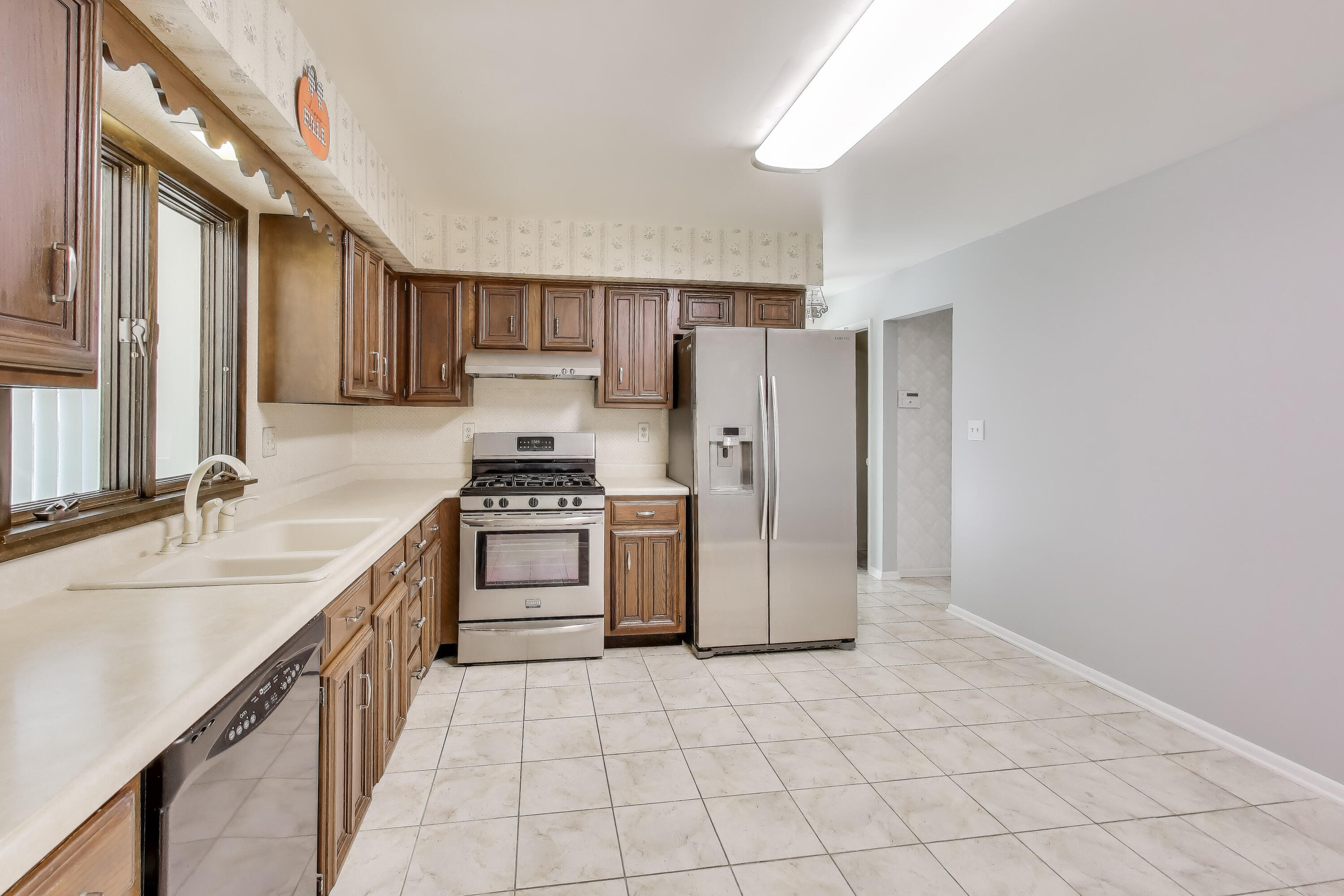 9449 Primrose Lane Munster, IN 46321 - Photo 8 of 34 a kitchen with a sink cabinets and stainless steel appliances