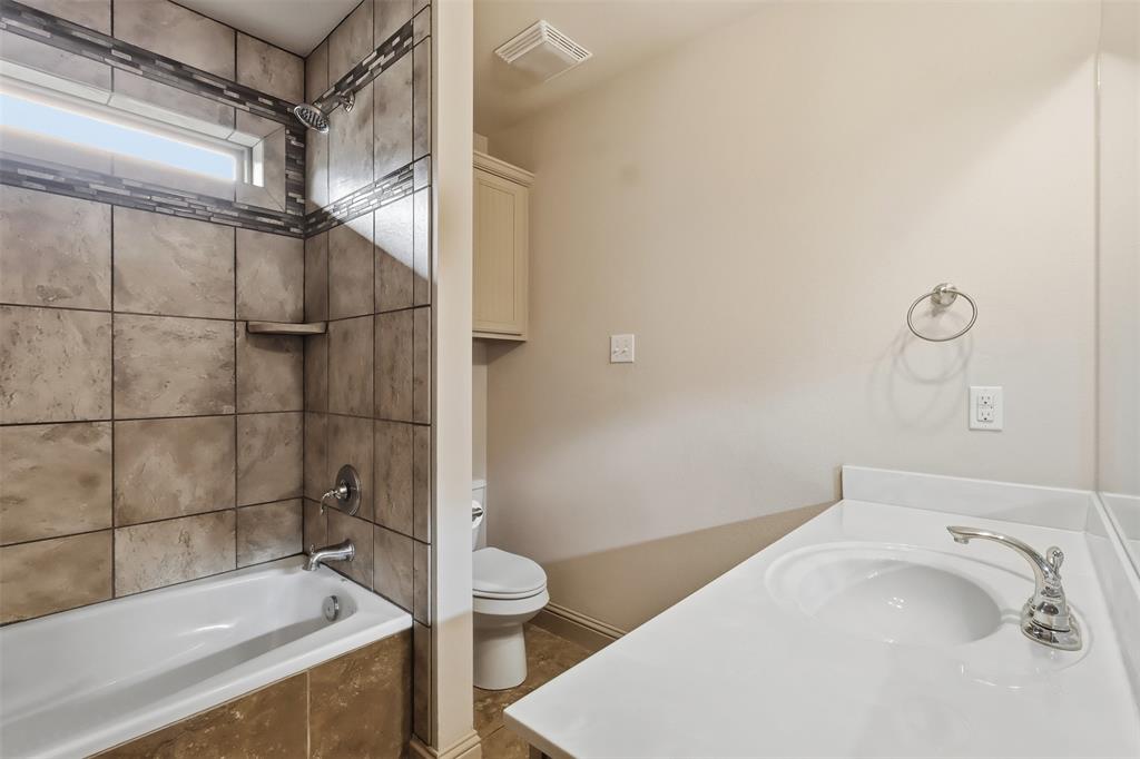 2512 Guinn Farms Road Tyler, TX 75707 - Photo 28 of 29 a bathroom with a sink and toilet