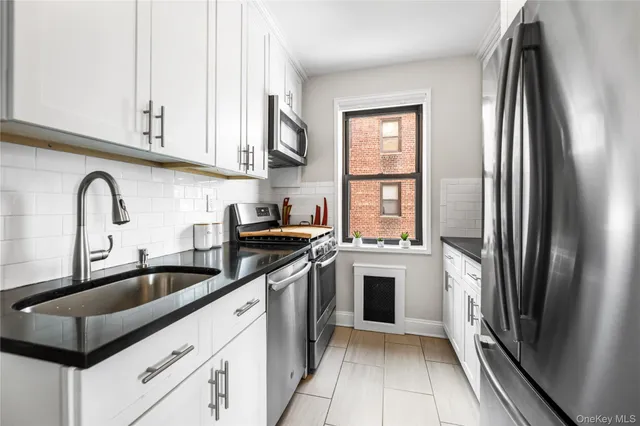 a kitchen with stainless steel appliances a refrigerator sink and cabinets