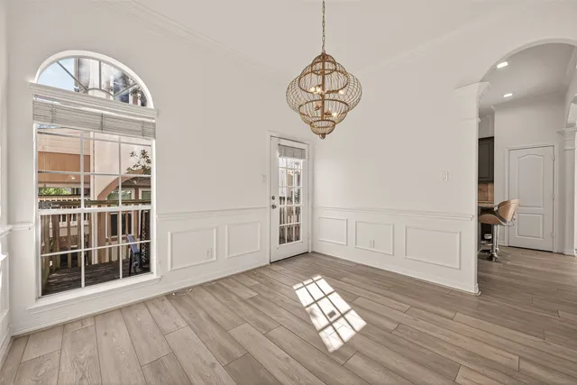 a view of empty room with wooden floor and window
