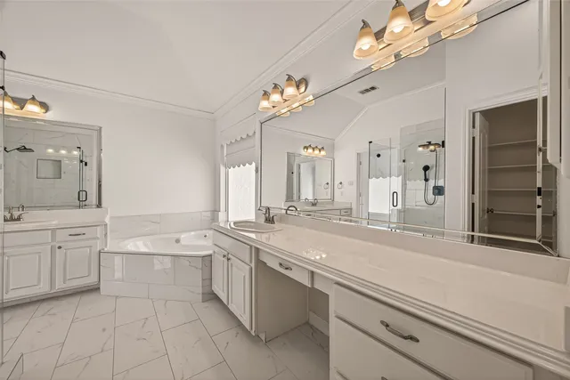 a spacious bathroom with a sink a large mirror and a bathtub