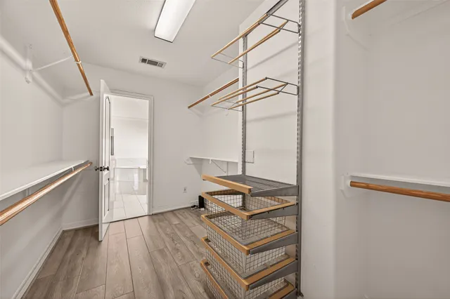 a view of a room with wooden floor and white walls