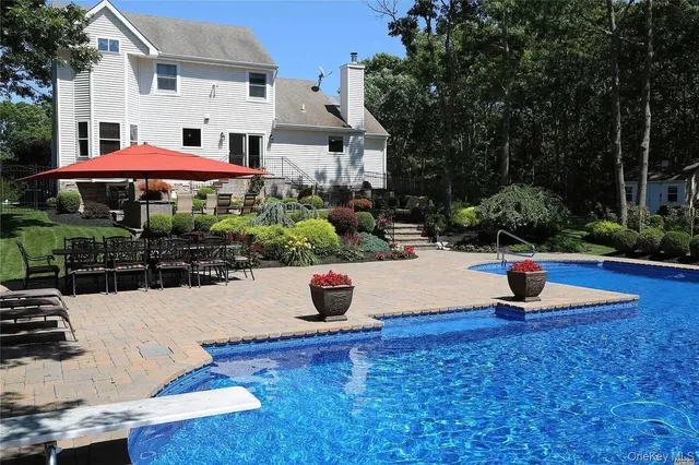 a swimming pool with outdoor seating and yard