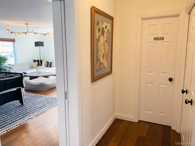 a view of a hallway with wooden floor windows and livingroom