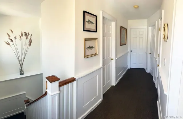 a bedroom with a bed lamps and a large mirror