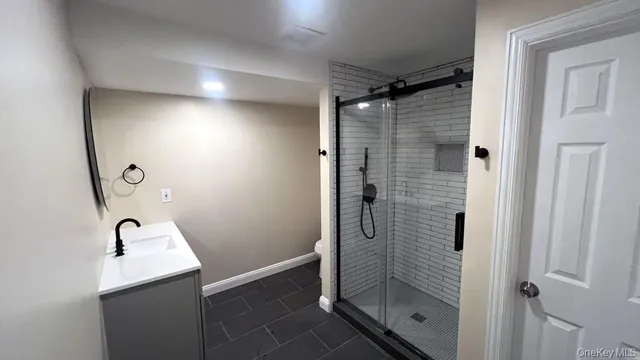 a bedroom with a bed and a night stand