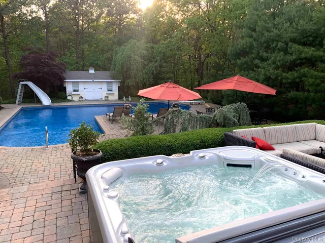 a view of a backyard with sitting area