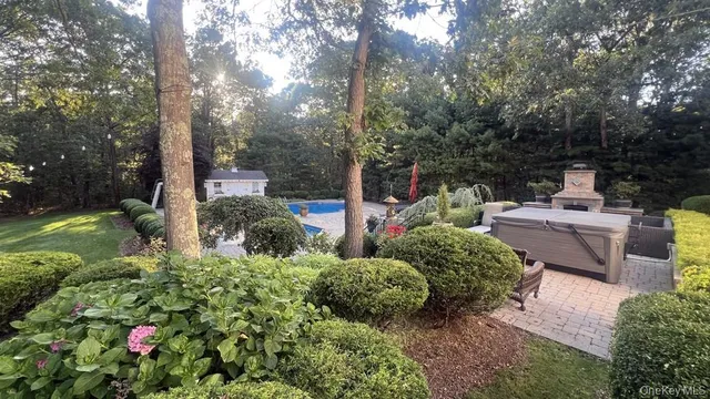 a view of a garden with flowers and trees