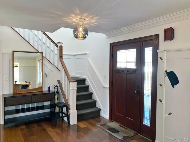 a view of entryway and hall with wooden floor