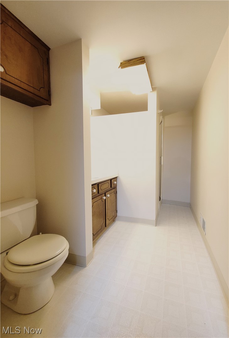 249 Rufener Street Rittman, OH 44270 - Photo 30 of 36 Basement bathroom with vinyl flooring, shower, vanity and commode
