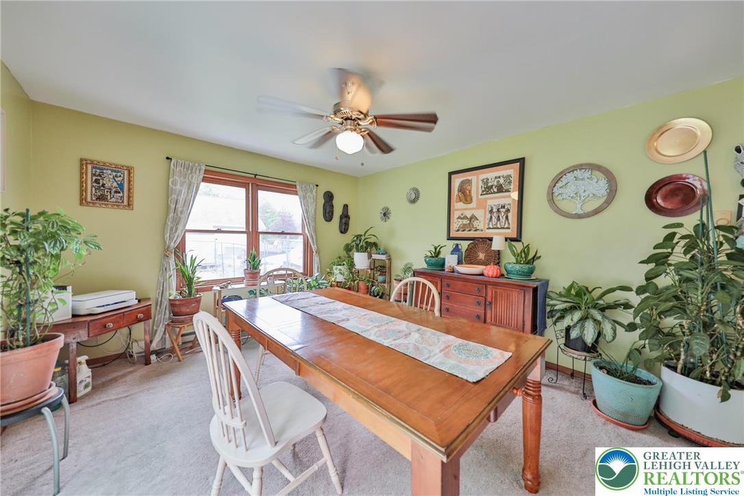 4608 Pine Ridge Drive West Bushkill, PA 18324 - Photo 19 of 62 A cheerful dining room with plentiful natural light features a large window and a ceiling fan.