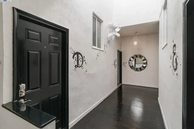 a view of a hallway with wooden floor
