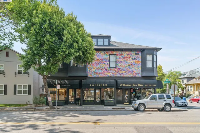 a view of a cars park in front of a building
