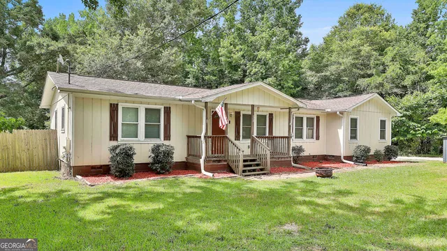 a front view of a house with a garden and porch