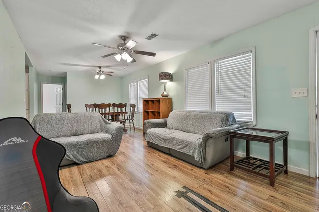 a living room with furniture and a chandelier