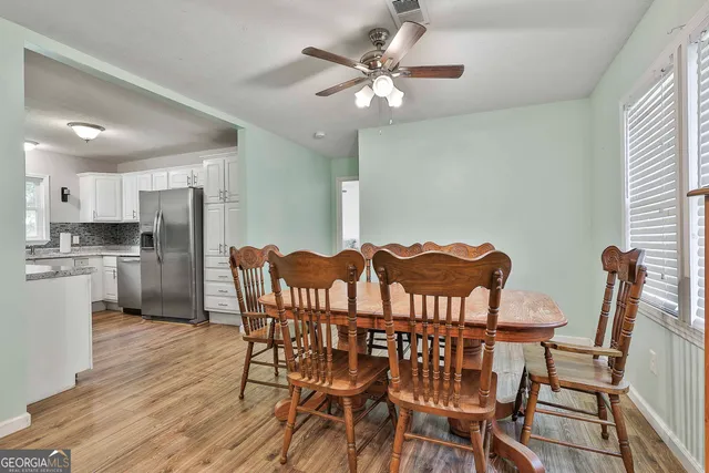 a view of a dining room with furniture and a chandelier