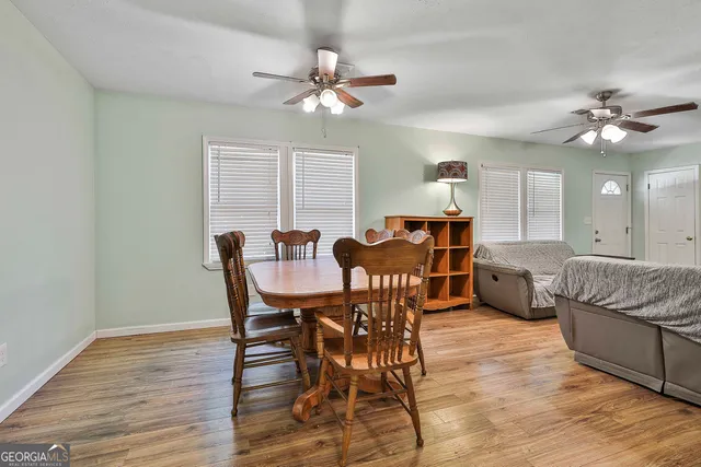 a view of a dining room with furniture and chandelier