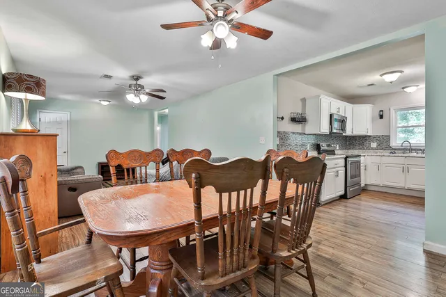 a view of a dining room with furniture and wooden floor