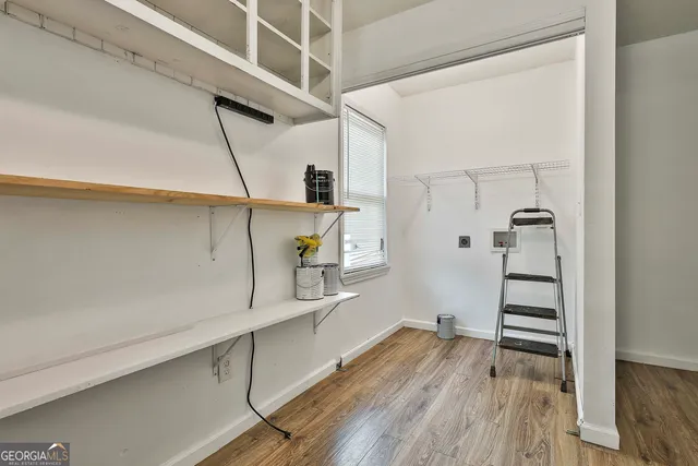 a view of walk in closet with empty racks