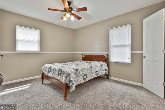 a bedroom with a bed rug and window